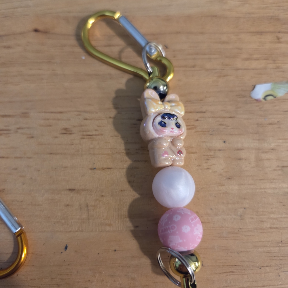 Charming Pink and Gold Keychain with Doll Accent Hand Made .